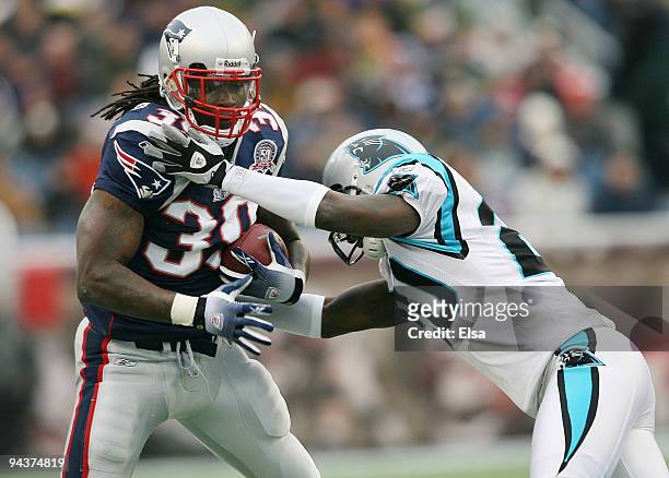 Laurence Maroney of the New England Patriots runs with the ball in the first half against Chris Gamble of the Carolina Panthers on December 13, 2009...