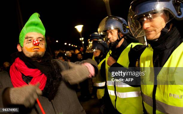 Demonstrators dressed as a clown parades in front of police outside the "climate prison" in a peaceful protest on December 13, 2009 during the...