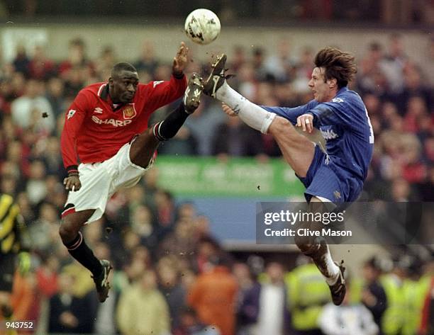 Andy Cole of Manchester United and Craig Burley of Chelsea jump for the ball during the FA Cup Semi-Final at Villa Park in Birmingham, England....