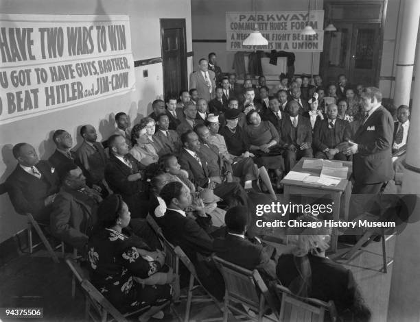 Group of men and women gather at the Parkway Community House to discuss labor and civil rights issues during World War II, Chicago, IL, ca. 1945.