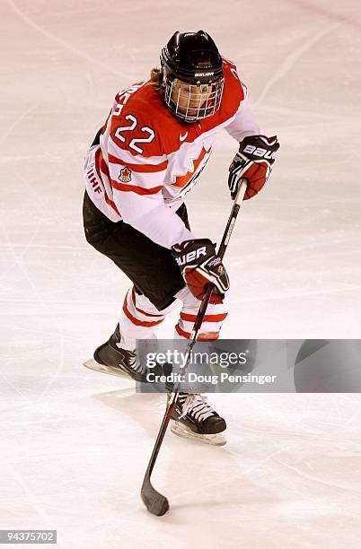 Hayley Wickenheiser of Canada controls the puck as she skates against the USA during their Women's Ice Hockey match at the Magness Arena on the...