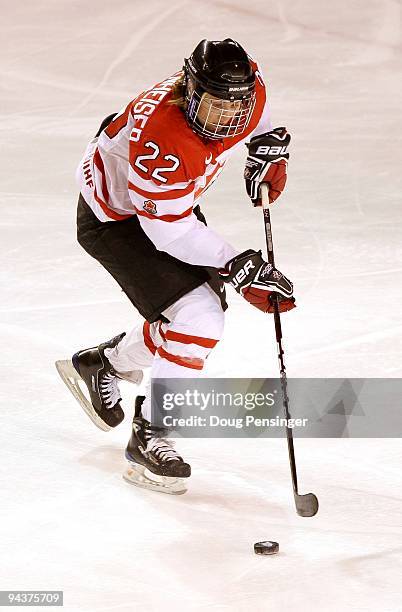 Hayley Wickenheiser of Canada controls the puck as she skates against the USA during their Women's Ice Hockey match at the Magness Arena on the...