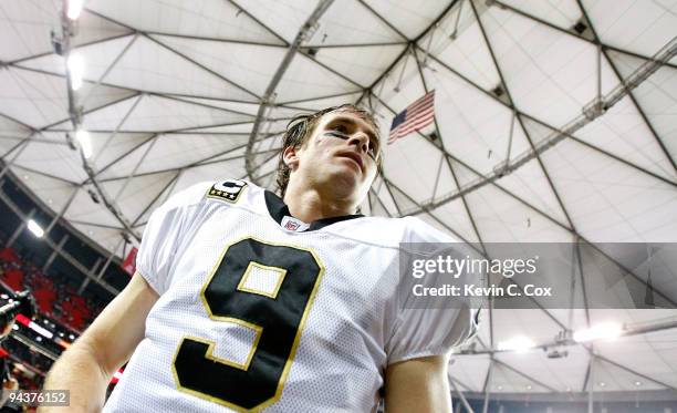 Quarterback Drew Brees of the New Orleans Saints walks off the field after their 26-23 win over the Atlanta Falcons at Georgia Dome on December 13,...