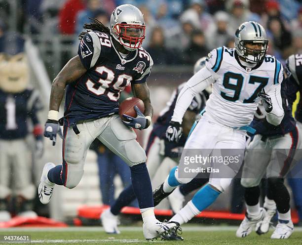 Laurence Maroney of the New England Patriots carries the ball as Hilee Taylor of the Carolina Panthers defends on December 13, 2009 at Gillette...
