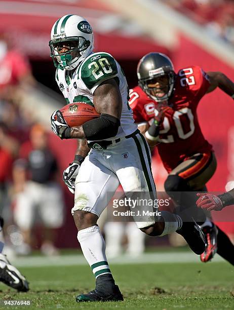Running back Thomas Jones of the New York Jets runs away from defensive back Ronde Barber of the Tampa Bay Buccaneers during the game at Raymond...