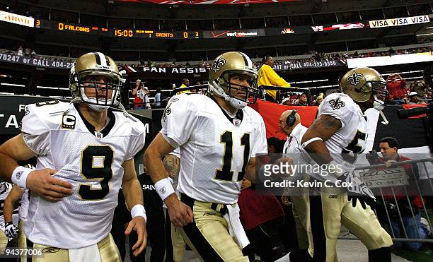 Quarterback Drew Brees and Mark Brunell of the New Orleans Saints take the field against the Atlanta Falcons at Georgia Dome on December 13, 2009 in...