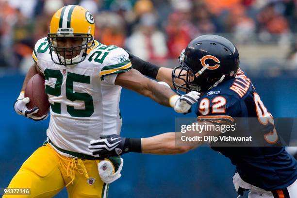 Ryan Grant of the Green Bay Packers rushes against Hunter Hillenmeyer of the Chicago Bears at Soldier Field on December 13, 2009 in Chicago,...