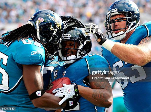 Maurice Jones-Drew of the Jacksonville Jaguars celebrates after scoring a 1-yard rushing touchdown with Brad Meester and Kynan Forney during the game...