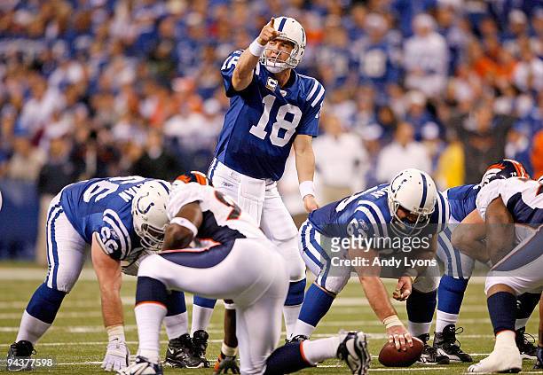 Peyton Manning of the Indianapolis Colts gives instructions to his team at the line of scrimmage during the NFL game against the Denver Broncos at...