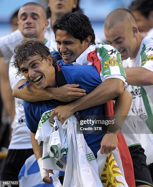 Uruguayan forward Sebastian Fernandez of Banfield celebrates with teammate Paraguayan defender Jose Devaca after winning Argentina's first division...