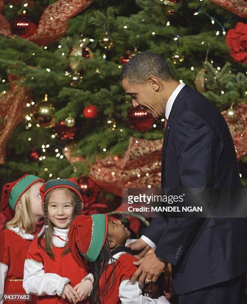 President Barack Obama chat with children dressed as elves as he arrives to attend the Christmas in Washington Celebration December 13, 2009 at the...