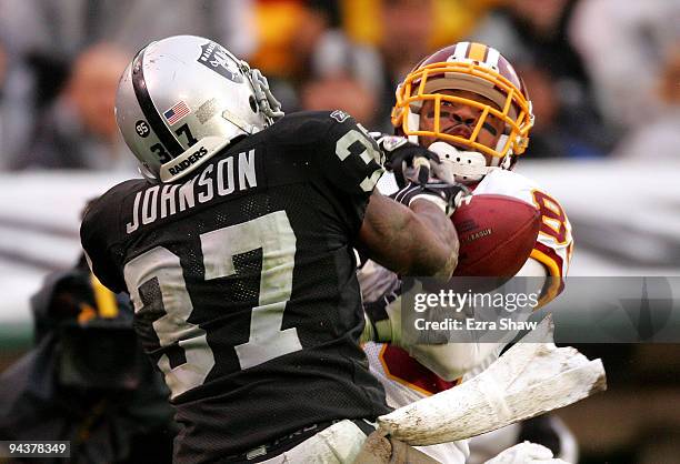 Chris Johnson of the Oakland Raiders breaks up a pass intended for Santana Moss of the Washington Redskins at Oakland-Alameda County Coliseum on...