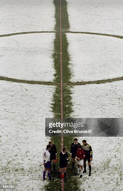 Phillipe Albert of Anderlecht and Franco Baresi of Milan prepare to play on a snow covered pitch before the Champions League Group B match at the...