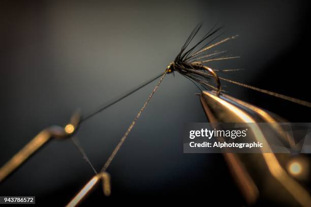 close up of vice and fishing fly - fly casting stock pictures, royalty-free photos & images