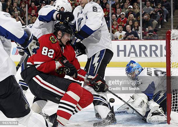 Tomas Kopecky of the Chicago Blackhawks tries to get the puck past goalie Antero Niittymaki of the Tampa Bay Lightning on December 13, 2009 at the...