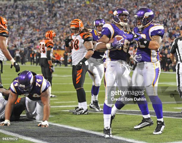 Adrian Peterson and Naufahu Tahi of the Minnesota Vikings celebrate following a touchdown during an NFL game against the Cincinnati Bengals at the...