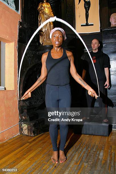 Suzanne "Africa" Engo works with trainer Daniel Giel as she trains to run to raise awareness for AIDS In Africa at Sal Anthony's Movement Salon on...