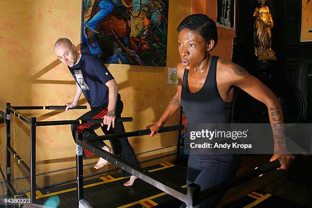 Suzanne "Africa" Engo works with trainer Daniel Giel as she trains to run to raise awareness for AIDS In Africa at Sal Anthony's Movement Salon on...