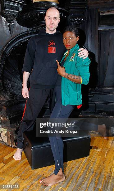 Suzanne "Africa" Engo works with trainer Daniel Giel as she trains to run to raise awareness for AIDS In Africa at Sal Anthony's Movement Salon on...
