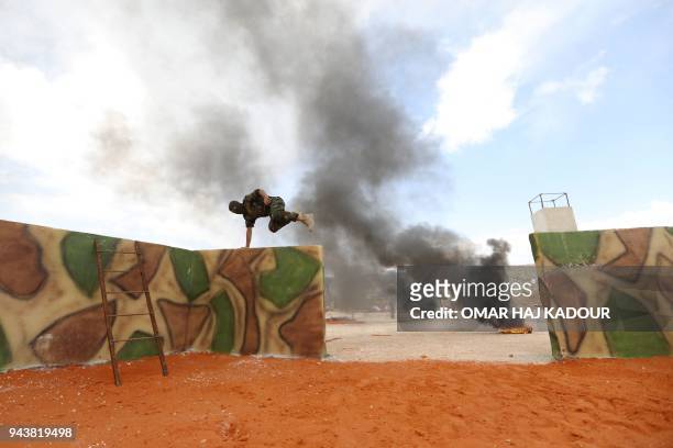Fighters from the Jaysh al-Izza , affiliated with the Turkish-backed Free Syrian Army, take part in a training session in the northwestern Syrian...