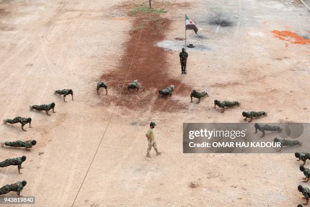 Fighters from the Jaysh al-Izza , affiliated with the Turkish-backed Free Syrian Army, take part in a training session in the northwestern Syrian...