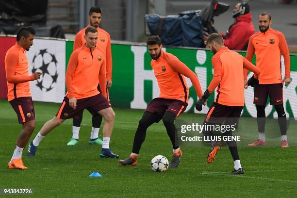 Barcelona's Portuguese midfielder Andre Gomes kicks a ball during a training session at the Olympic Stadium in Rome on April 9, 2018 on the eve of...
