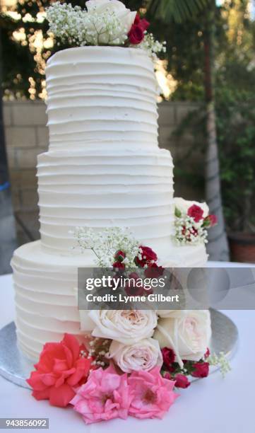 a table is set up with roses on a wedding cake for a wedding reception - cake tier stock pictures, royalty-free photos & images