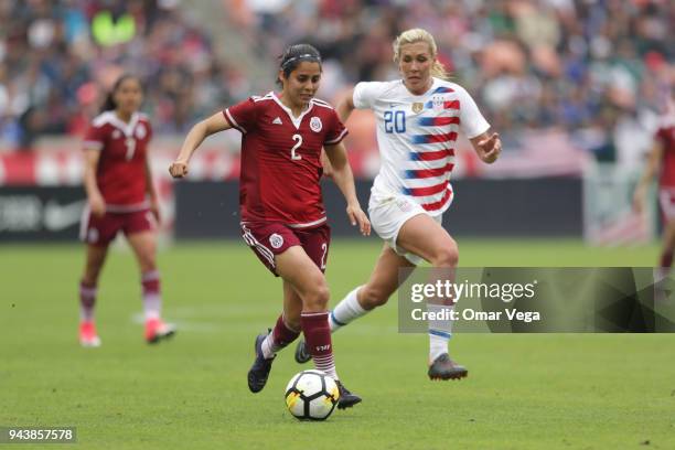 Kenti Robles of Mexico and Allie Long of United States fight for the ball during the match between Mexico and United States at BBVA Compass Stadium...