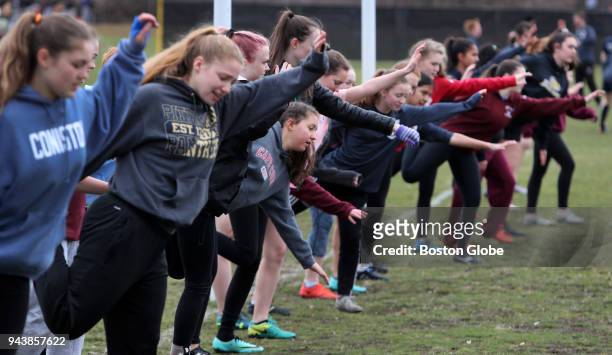 Belmont players stretch during pre-practice exercises at a rugby practice session at Belmont High School in Belmont, MA on April 2, 2018. When Greg...