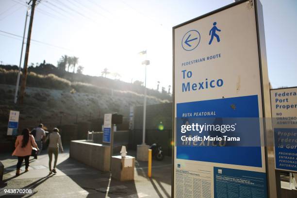 People walk to enter Mexico on foot at the San Ysidro port of entry on April 9, 2018 in San Ysidro, California. President Trump has issued a decree...