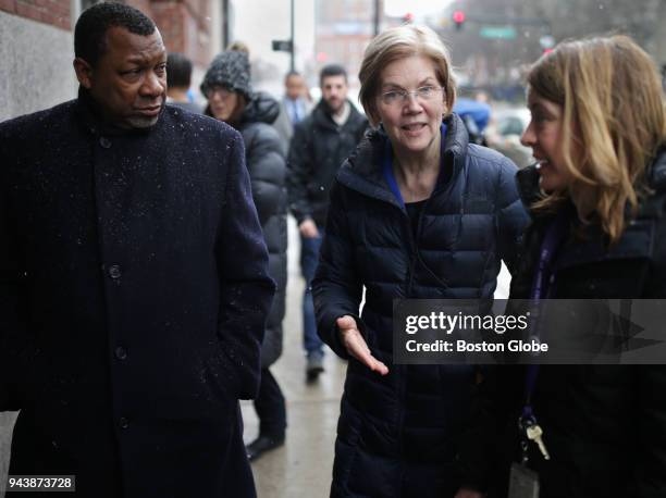 Suffolk County Sheriff Steven W. Tompkins, left, walks with U.S. Senator Elizabeth Warren, center, and Dr..Jessie Gaeta, right, to the Boston Health...