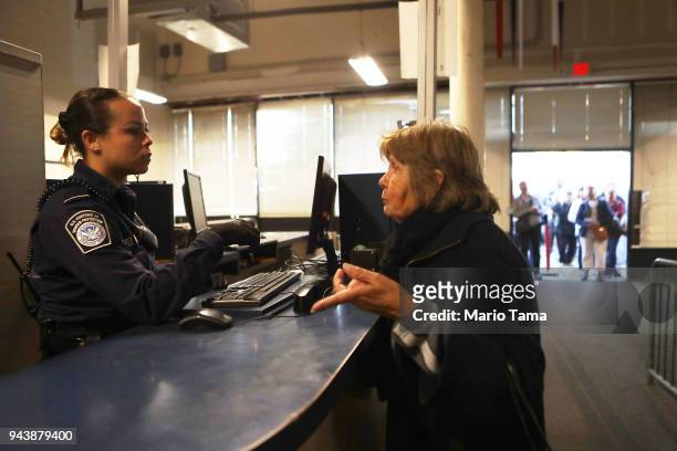 Customs and Border Protection officer inspects the document of a woman entering the United States at the San Ysidro port of entry on April 9, 2018 in...