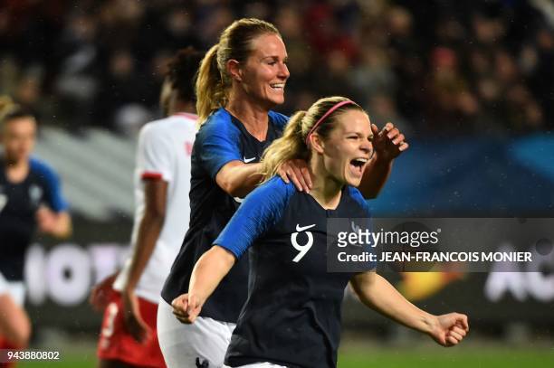France's forward Eugenie Le Sommer is congratulated after scoring by teammate midfielder Amandine Henry during the friendly womens football match...