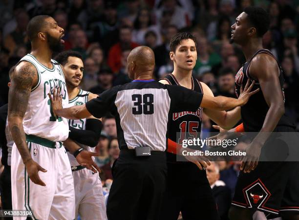 Official Michael Smill separates Boston Celtics forward Marcus Morris and Chicago Bulls forward Bobby Portis . Both received technical fouls and were...