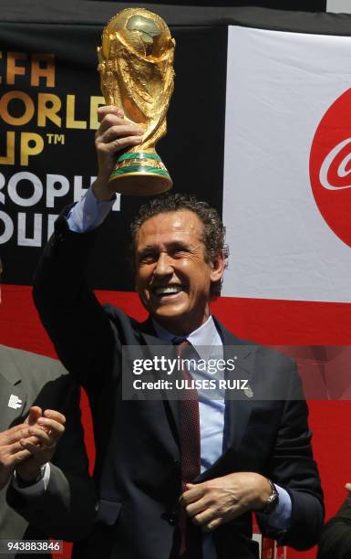 Argentina's former football player Jorge Valdano displays the FIFA World Cup trophy upon arrival at Miguel Hidalgo International Airport in...