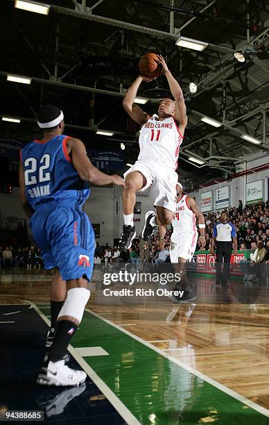 Will Blalock of the Maine Red Claws scores two points and gets a foul shot as he drives into the paint, bounces off Mustafa Shakur of the Tulsa 66ers...