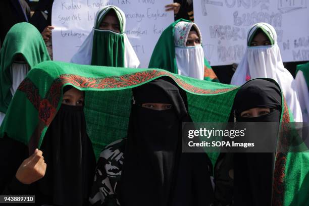 Females protesters seen at the demonstration. Hundreds of Muslims from the Islamic Defenders Front Aceh protest Sukmawati Soekarnoputri who has...