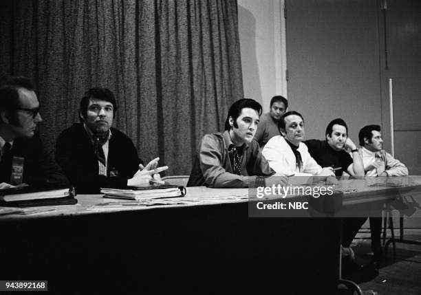 Pictured: Producer Bones Howe, producer and director Steve Binder, Elvis Presley, executive producer Bob Finkel, Joe Esposito during a press...