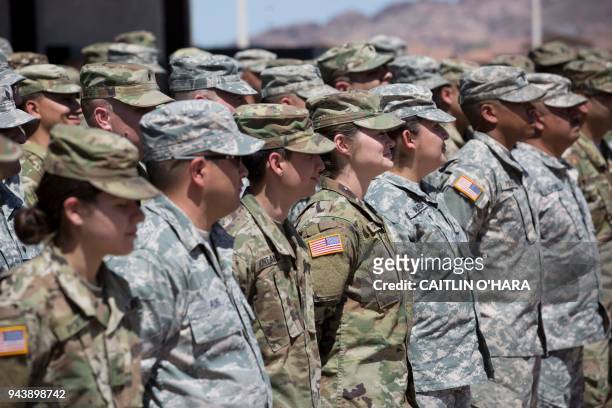 Members of the Arizona National Guard listen to instructions on April 9 at the Papago Park Military Reservation in Phoenix. Arizona deployed its...