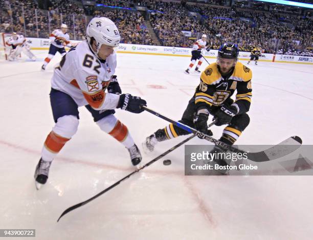 Boston Bruins center David Krejci battles Florida Panthers center Denis Malgin for control of the puck during the second period. The Boston Bruins...
