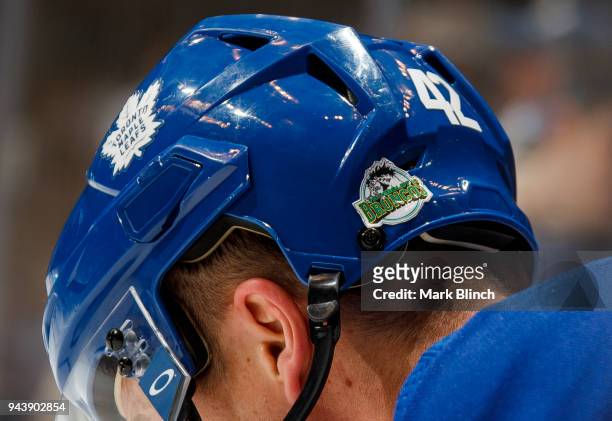 Tyler Bozak of the Toronto Maple Leafs wears a sticker on his helmet in honour of the victims of a traffic accident which took the lives of 15 people...