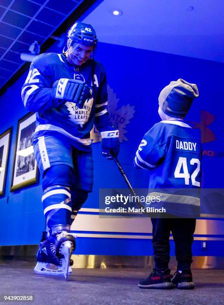 Tyler Bozak of the Toronto Maple Leafs greets his son Kanon in front of the dressing room before playing the Montreal Canadiens at the Air Canada...