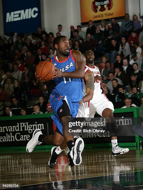 Cecil Brown of the Tulsa 66ers drives past Billy Thomas of the Maine Red Claws during the game on December 13, 2009 at the Portland Expo in Portland,...