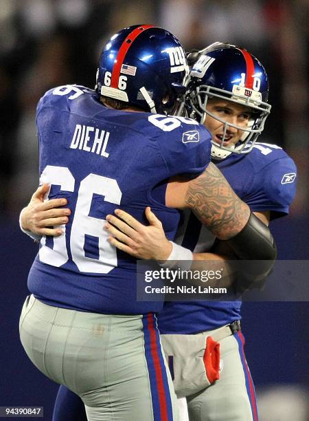 Eli Manning of the New York Giants celebrates with David Diehl after a touchdown pass in the third quarter against the Philadelphia Eagles at Giants...