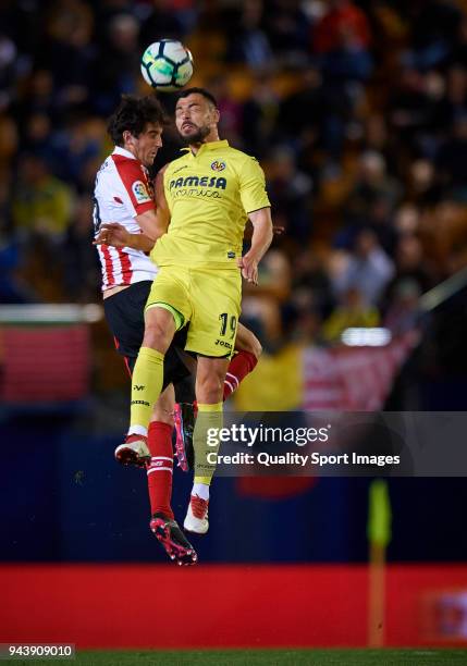 Javi Fuego of Villarreal competes for the ball with Mikel San Jose of Athletic Club during the La Liga match between Villarreal and Athletic Club at...