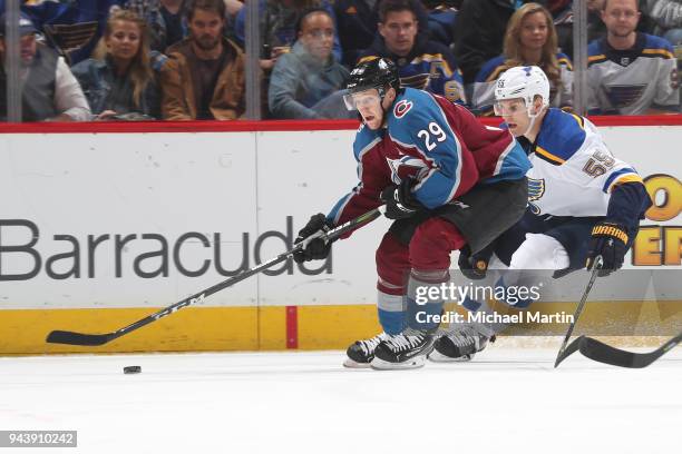 Nathan MacKinnon of the Colorado Avalanche skates against Colton Parayko of the St. Louis Blues at the Pepsi Center on April 7, 2018 in Denver,...