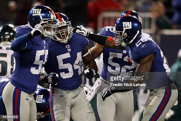 Jonathan Goff of the New York Giants celebrates after an interception in the third quarter with teammates Danny Clark, Michael Boley and Aaron Rouse...