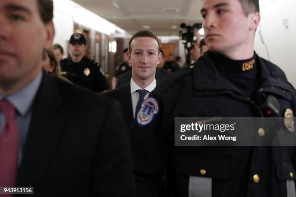 Facebook CEO Mark Zuckerberg is escorted by U.S. Capitol Police as he walks in a hallway prior to a meeting with U.S. Sen. John Thune , committee...