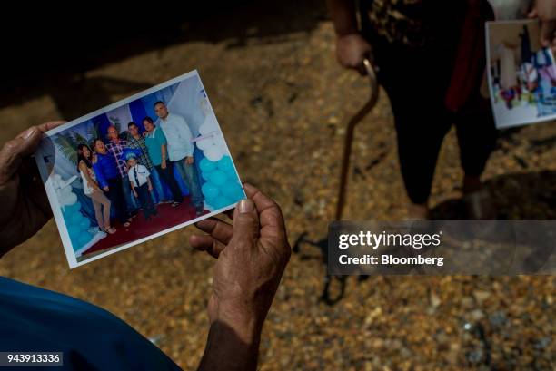 Father displays a photograph of his son, who was killed during a military operation in the Cicapra mine, in Soledad, Bolivar State, Venezuela, on...