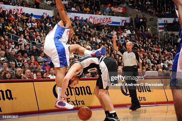 Eric Gordon of the Los Angeles Clippers loses his balance against Manu Ginobili of the San Antonio Spurs at Staples Center on December 13, 2009 in...